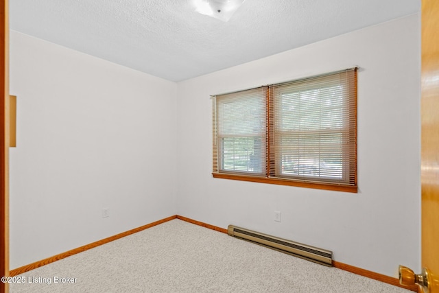 85 Joseph Ave, Cecilia, KY 42724 - spare room featuring a baseboard heating unit, carpet, and a textured ceiling