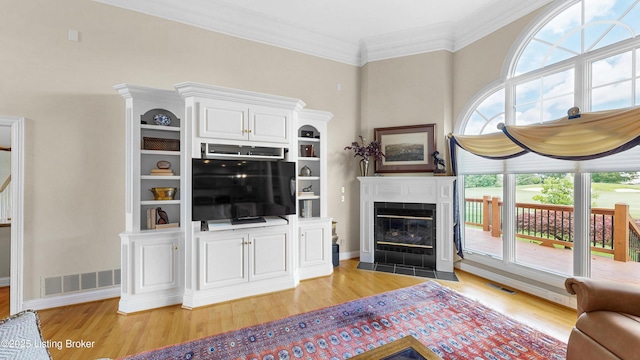 2221 Highland Springs Pl, Louisville, KY 40245 - living room featuring light wood-type flooring, a tile fireplace, and crown molding