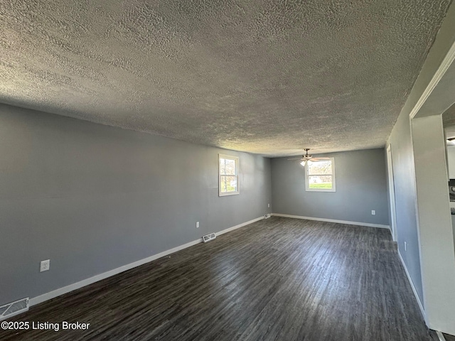 2130 Rabbit Run Rd, Vine Grove, KY 40175 - unfurnished room with a textured ceiling, dark wood-style flooring, and a ceiling fan