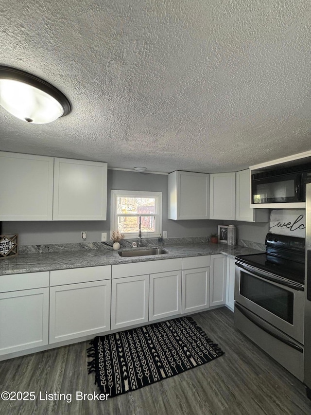 2130 Rabbit Run Rd, Vine Grove, KY 40175 - kitchen featuring stainless steel electric range, black microwave, a textured ceiling, dark wood-style floors, and white cabinetry