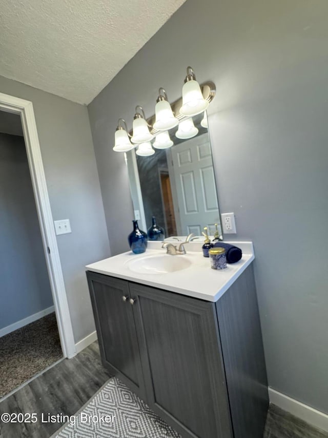 2130 Rabbit Run Rd, Vine Grove, KY 40175 - bathroom featuring wood finished floors, vanity, a textured ceiling, and a chandelier