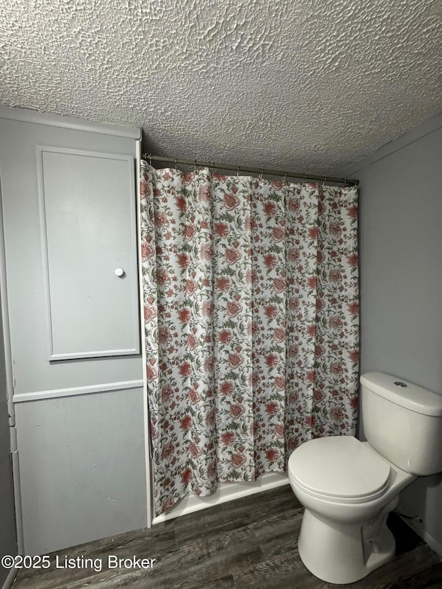 2130 Rabbit Run Rd, Vine Grove, KY 40175 - full bath with wood finished floors, a textured ceiling, and curtained shower