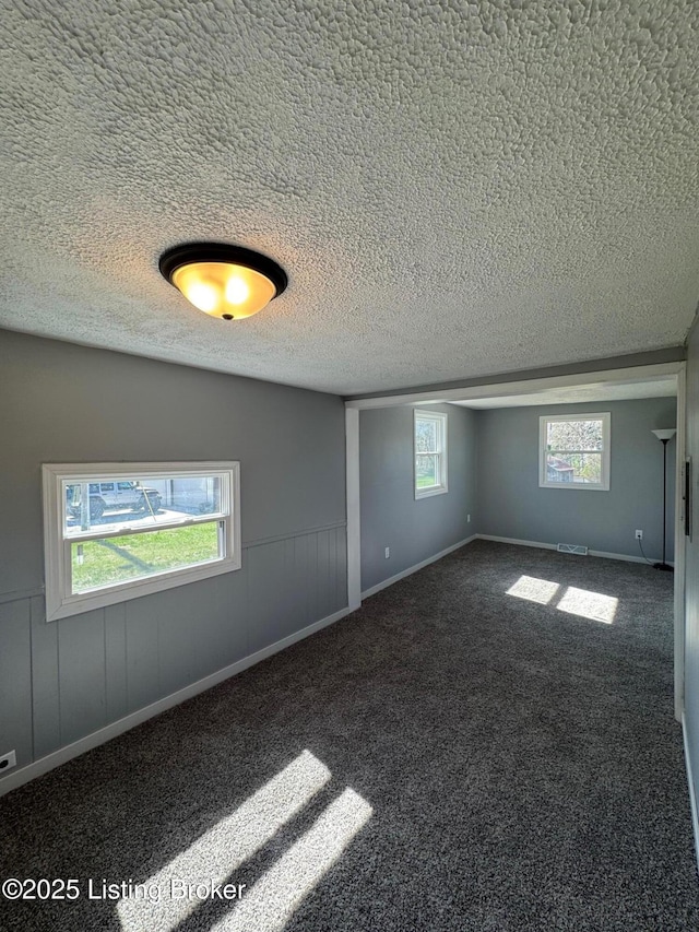 2130 Rabbit Run Rd, Vine Grove, KY 40175 - empty room featuring a textured ceiling and dark colored carpet
