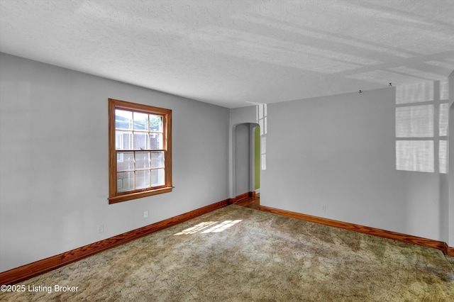 3010 Meade Ave, Louisville, KY 40217 - carpeted spare room with arched walkways and a textured ceiling