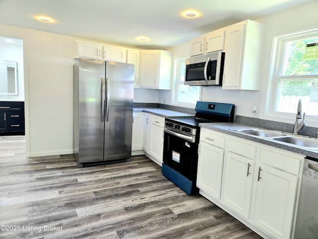 6910 Sylvania 4 Rd, Louisville, KY 40258 - kitchen featuring stainless steel appliances, white cabinetry, wood finished floors, and recessed lighting