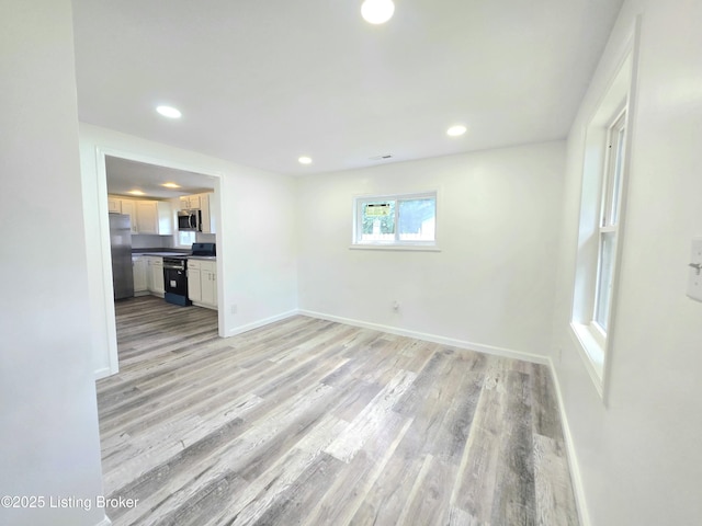 6910 Sylvania 4 Rd, Louisville, KY 40258 - unfurnished living room with light wood-type flooring and recessed lighting