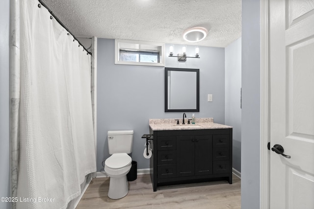 5613 Grandel Blvd, Louisville, KY 40258 - bathroom featuring wood finished floors, vanity, curtained shower, and a textured ceiling