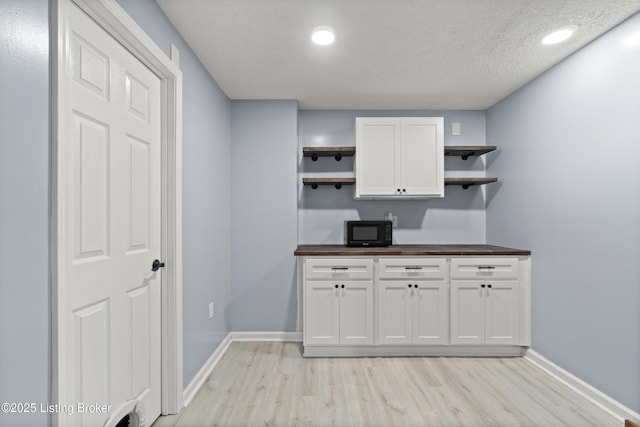 5613 Grandel Blvd, Louisville, KY 40258 - kitchen featuring open shelves, black microwave, wooden counters, light wood-style flooring, and white cabinetry