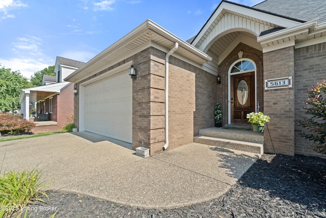5613 Grandel Blvd, Louisville, KY 40258 - doorway to property with a garage, driveway, brick siding, and roof with shingles