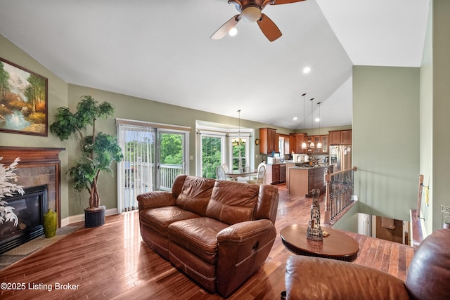 1126 Lagrange Rd, New Castle, KY 40050 - living room featuring a ceiling fan, vaulted ceiling, wood finished floors, a tiled fireplace, and recessed lighting