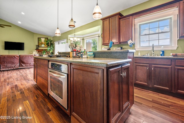 1126 Lagrange Rd, New Castle, KY 40050 - kitchen featuring appliances with stainless steel finishes, dark wood-style flooring, lofted ceiling, a kitchen island, and decorative light fixtures
