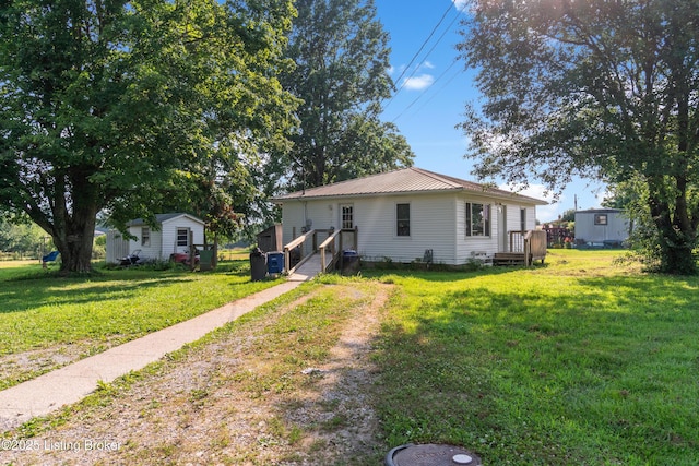 1255 Holy Cross Rd, Loretto, KY 40037 - rear view of house with a lawn, an outbuilding, and a metal roof