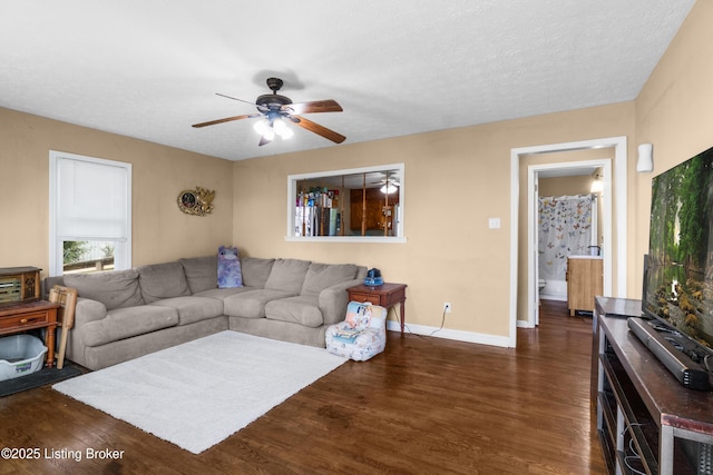 1255 Holy Cross Rd, Loretto, KY 40037 - living room featuring a ceiling fan, dark wood-type flooring, and a textured ceiling