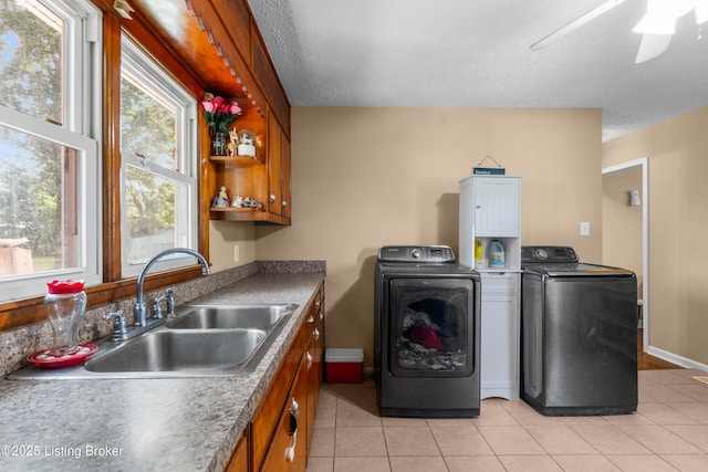 1255 Holy Cross Rd, Loretto, KY 40037 - laundry area with washing machine and dryer, cabinet space, light tile patterned floors, ceiling fan, and a textured ceiling