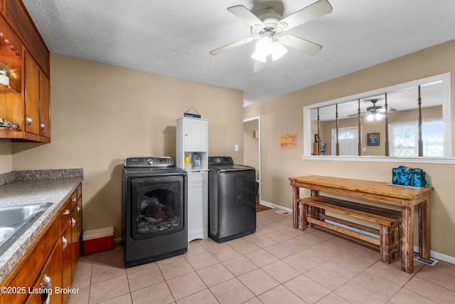 1255 Holy Cross Rd, Loretto, KY 40037 - washroom featuring a ceiling fan, separate washer and dryer, cabinet space, and light tile patterned floors