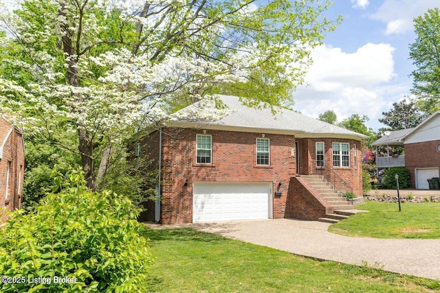 9829 Galene Dr, Jeffersontown, KY 40299 - view of front of property with a garage, driveway, brick siding, and a front yard