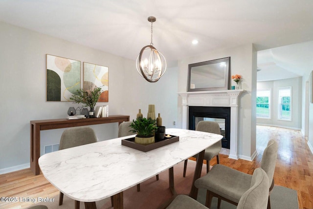 9829 Galene Dr, Jeffersontown, KY 40299 - dining space featuring a chandelier, light wood-style flooring, a multi sided fireplace, and recessed lighting