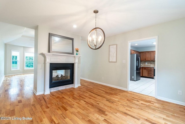9829 Galene Dr, Jeffersontown, KY 40299 - unfurnished living room with light wood-style floors, a chandelier, a multi sided fireplace, and recessed lighting