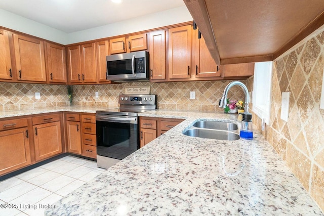 9829 Galene Dr, Jeffersontown, KY 40299 - kitchen featuring appliances with stainless steel finishes, brown cabinetry, light stone counters, and tasteful backsplash