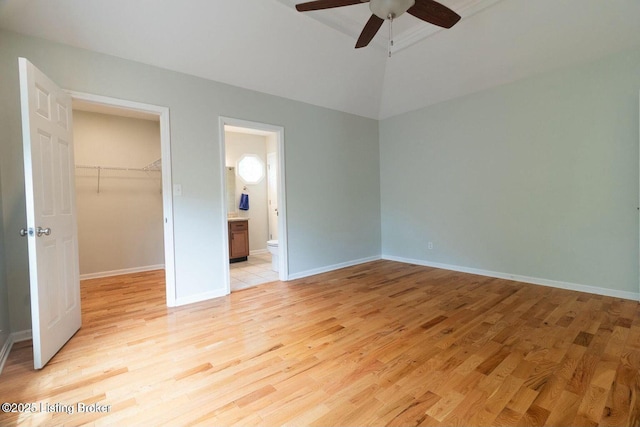 9829 Galene Dr, Jeffersontown, KY 40299 - unfurnished bedroom with light wood-style flooring, a walk in closet, a closet, connected bathroom, and a ceiling fan