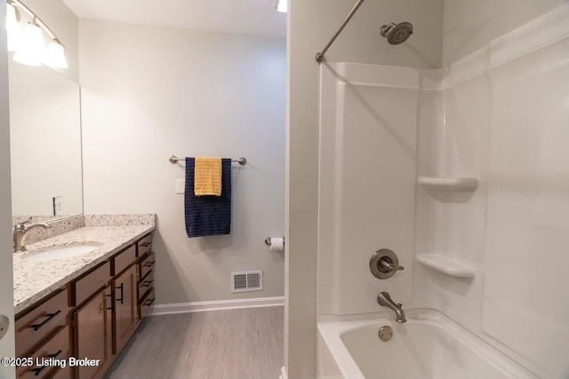 9829 Galene Dr, Jeffersontown, KY 40299 - bathroom with wood finished floors, shower / bath combination, and vanity