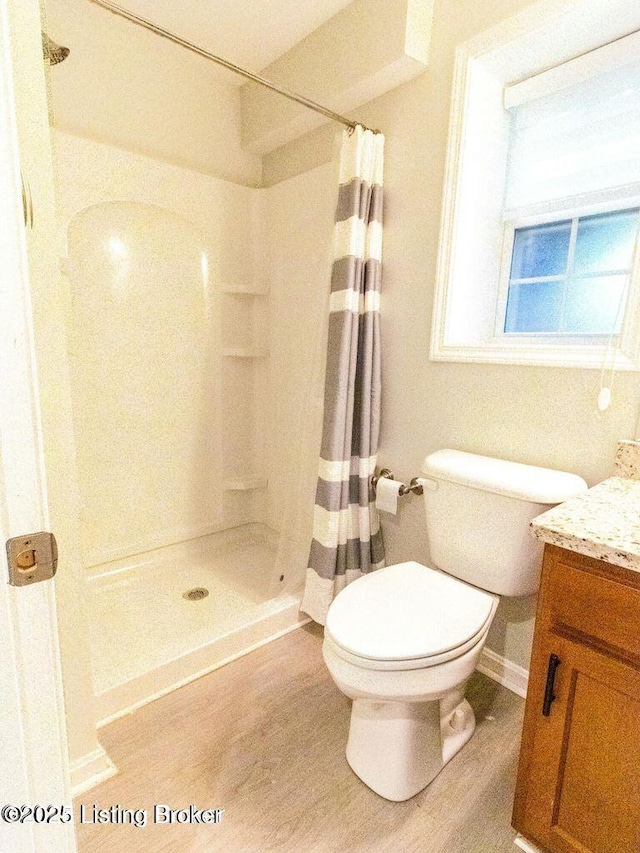 9829 Galene Dr, Jeffersontown, KY 40299 - full bath featuring vanity, curtained shower, and wood finished floors