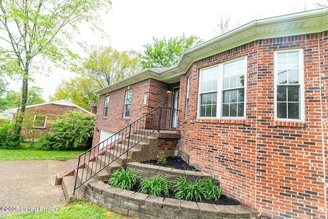 9829 Galene Dr, Jeffersontown, KY 40299 - view of side of property featuring brick siding, a garage, and driveway