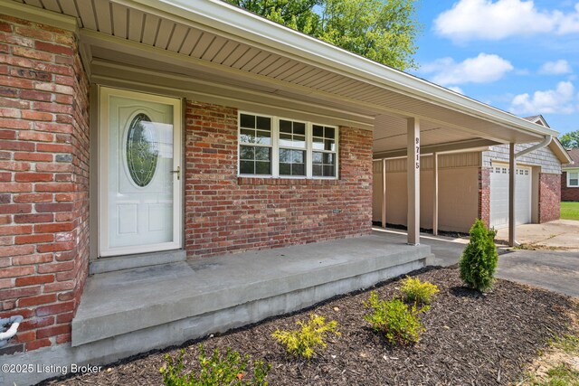 9715 Shady Acres Ln, Jeffersontown, KY 40299 - doorway to property with brick siding, a garage, and covered porch