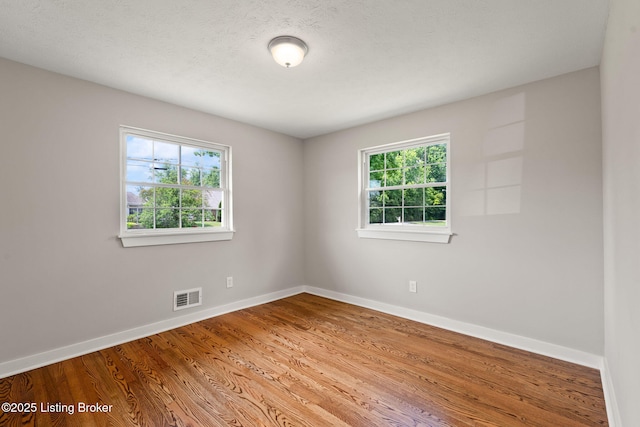 9715 Shady Acres Ln, Jeffersontown, KY 40299 - empty room with healthy amount of natural light and wood finished floors