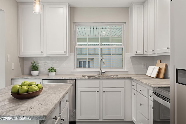 9715 Shady Acres Ln, Jeffersontown, KY 40299 - kitchen with appliances with stainless steel finishes, white cabinetry, tasteful backsplash, and light stone countertops