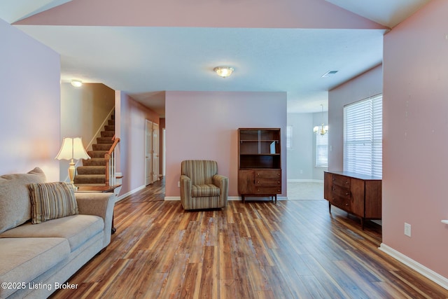 6813 Casey Pl, Louisville, KY 40229 - living room with wood finished floors, a chandelier, and stairway