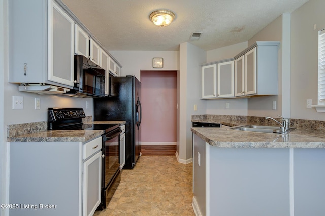 6813 Casey Pl, Louisville, KY 40229 - kitchen featuring black appliances, a peninsula, a textured ceiling, and light countertops