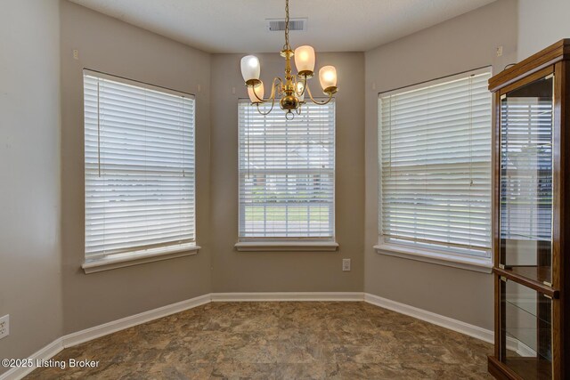 6813 Casey Pl, Louisville, KY 40229 - unfurnished dining area featuring a chandelier and stone finish floors
