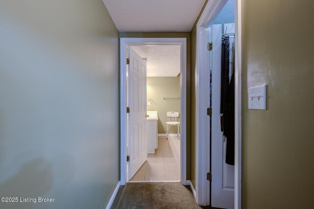 6813 Casey Pl, Louisville, KY 40229 - hall with carpet, tile patterned flooring, and a textured ceiling