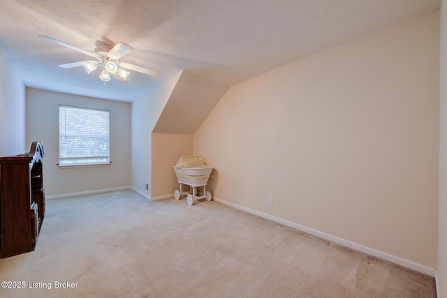 6813 Casey Pl, Louisville, KY 40229 - bonus room featuring light colored carpet, a ceiling fan, vaulted ceiling, and a textured ceiling