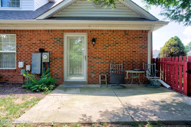 6813 Casey Pl, Louisville, KY 40229 - doorway to property featuring brick siding, a patio area, and a shingled roof
