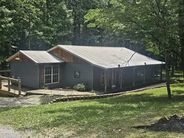 409 Woodhaven Ln, Leitchfield, KY 42754 - view of property exterior featuring a metal roof, a lawn, and a deck