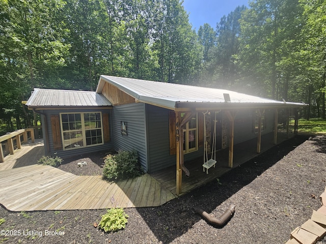 409 Woodhaven Ln, Leitchfield, KY 42754 - view of side of home with a metal roof and a wooden deck
