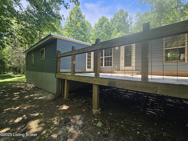 409 Woodhaven Ln, Leitchfield, KY 42754 - rear view of property featuring a wooden deck and a chimney