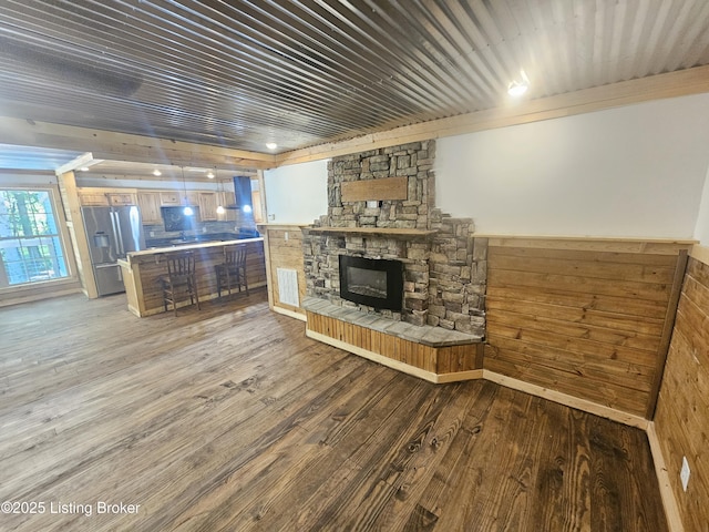 409 Woodhaven Ln, Leitchfield, KY 42754 - living room featuring wood finished floors, a fireplace, wainscoting, and wooden walls
