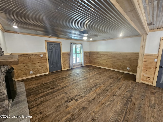 409 Woodhaven Ln, Leitchfield, KY 42754 - unfurnished living room featuring a wainscoted wall, dark wood finished floors, wood walls, and ceiling fan