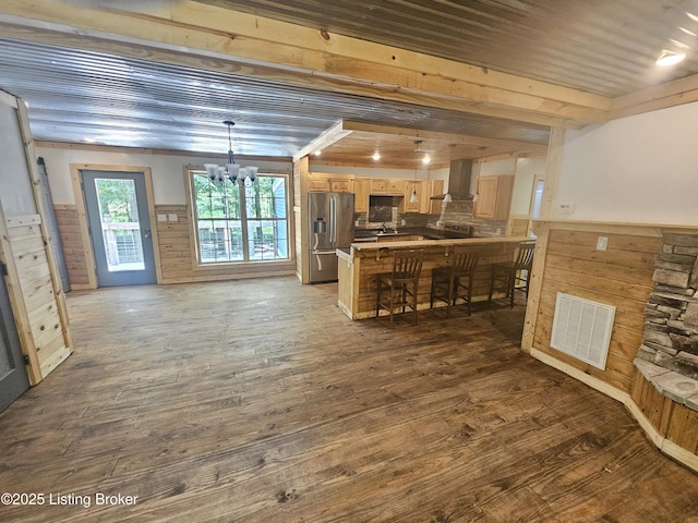 409 Woodhaven Ln, Leitchfield, KY 42754 - kitchen with stainless steel fridge with ice dispenser, wall chimney range hood, a chandelier, a wainscoted wall, and wood finished floors