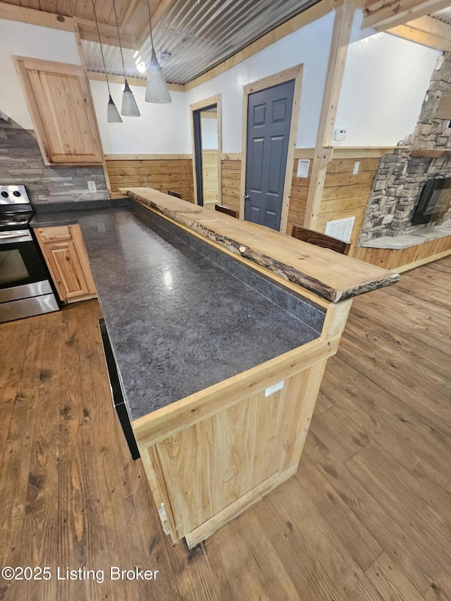409 Woodhaven Ln, Leitchfield, KY 42754 - kitchen featuring stainless steel electric range oven, dark countertops, light brown cabinets, wooden walls, and dark wood-style floors