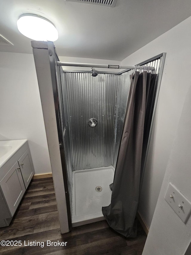 409 Woodhaven Ln, Leitchfield, KY 42754 - full bathroom featuring a stall shower, wood finished floors, and vanity
