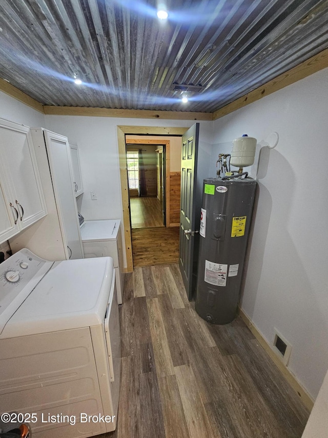 409 Woodhaven Ln, Leitchfield, KY 42754 - washroom with electric water heater, cabinet space, washer and clothes dryer, and dark wood-style flooring