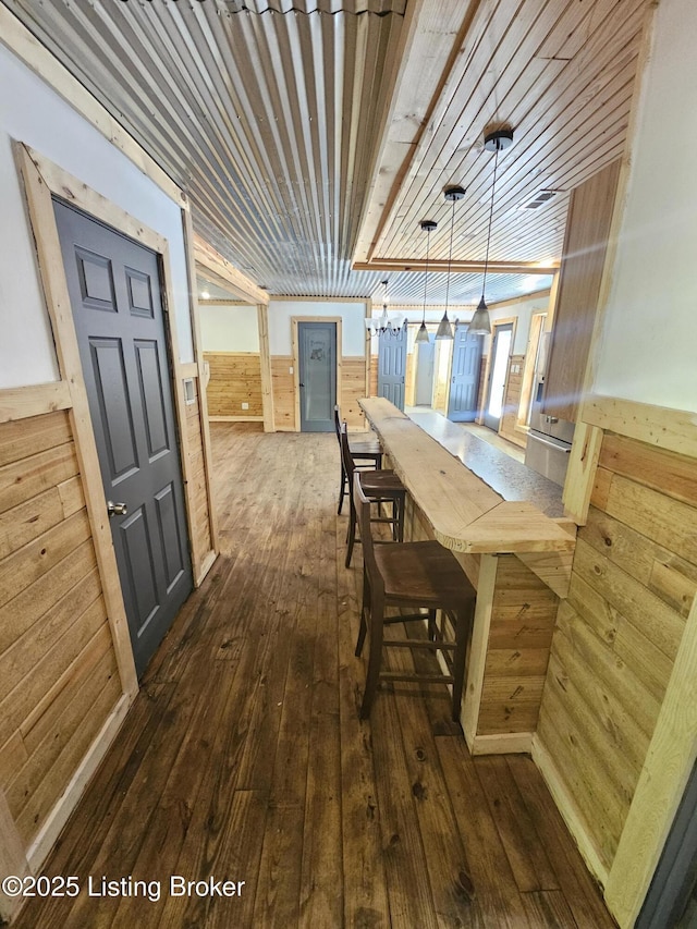 409 Woodhaven Ln, Leitchfield, KY 42754 - dining area featuring wooden walls, dark wood finished floors, and wainscoting