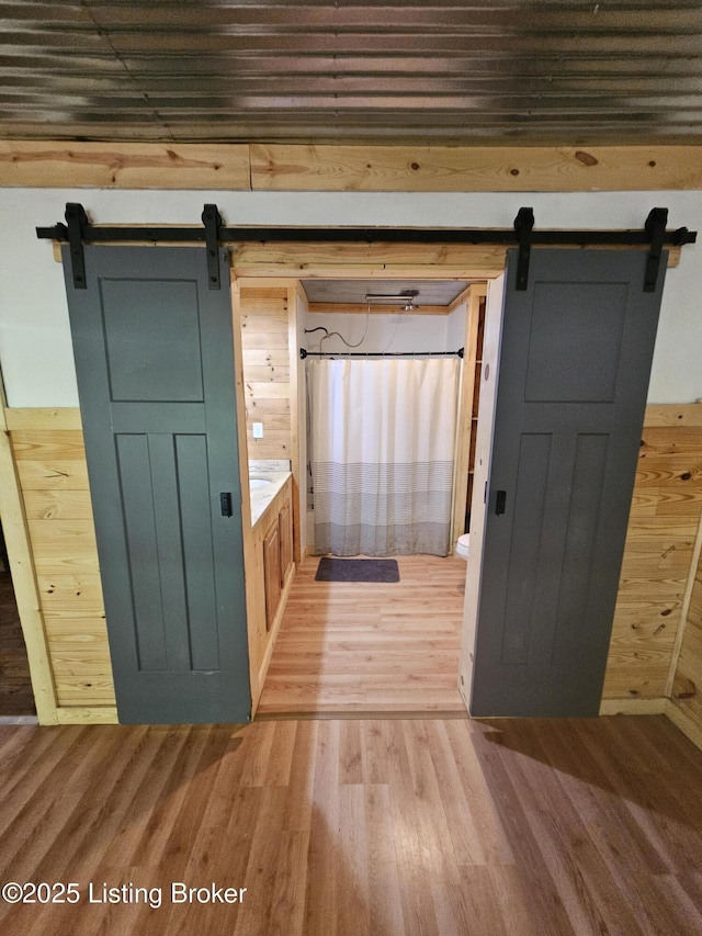 409 Woodhaven Ln, Leitchfield, KY 42754 - bathroom featuring wood finished floors, wood walls, and curtained shower
