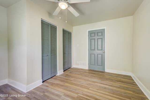 80 Kavanaugh St, Shelbyville, KY 40065 - unfurnished bedroom with two closets, light wood-type flooring, and a ceiling fan