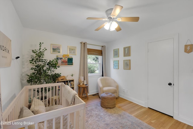 312 Norbourne Blvd, Louisville, KY 40207 - bedroom with a crib, wood finished floors, and a ceiling fan