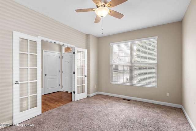 9006 Big Boulder Dr, Louisville, KY 40291 - unfurnished bedroom with french doors, carpet, and a ceiling fan